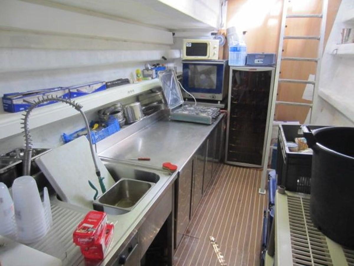 a kitchen with a sink and a microwave aboard ECOLORATO Yacht for Sale