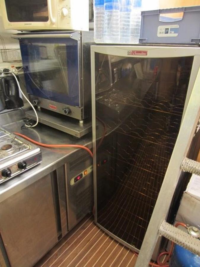 a kitchen with a glass door aboard ECOLORATO Yacht for Sale