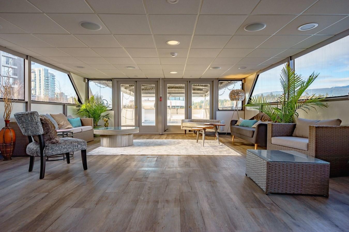 a room with a wood floor and a wood floor and a large window aboard MAGIC CHARM Yacht for Sale