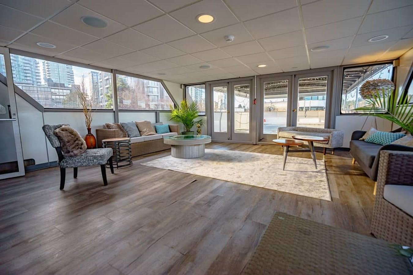 a living room with a wood floor aboard MAGIC CHARM Yacht for Sale