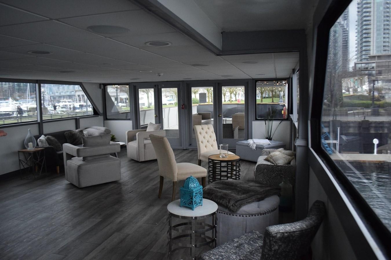a living room with a large window aboard MAGIC CHARM Yacht for Sale