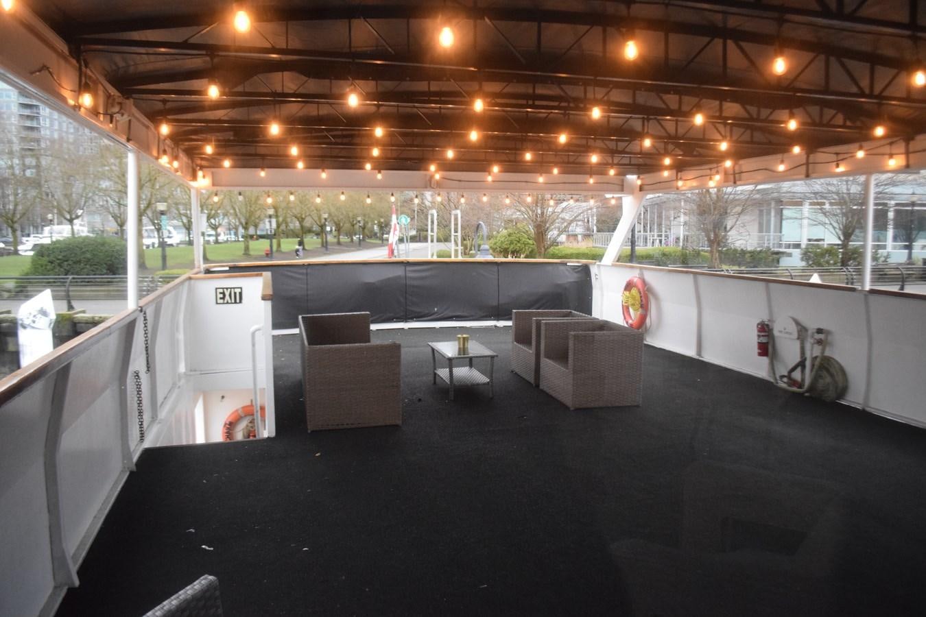 a room with tables and chairs aboard MAGIC CHARM Yacht for Sale