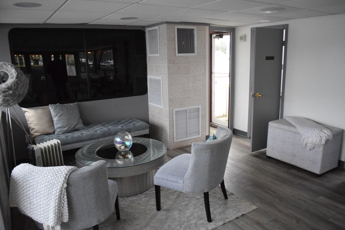 a living room with a couch and a table aboard MAGIC CHARM Yacht for Sale