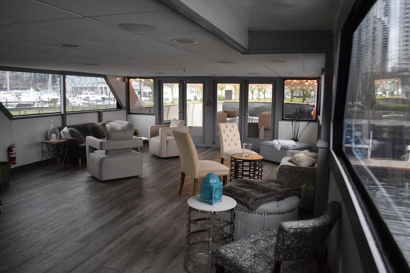 a living room with a large window aboard MAGIC CHARM Yacht for Sale