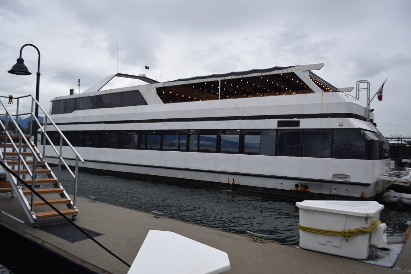 a large cruise ship docked aboard MAGIC CHARM Yacht for Sale