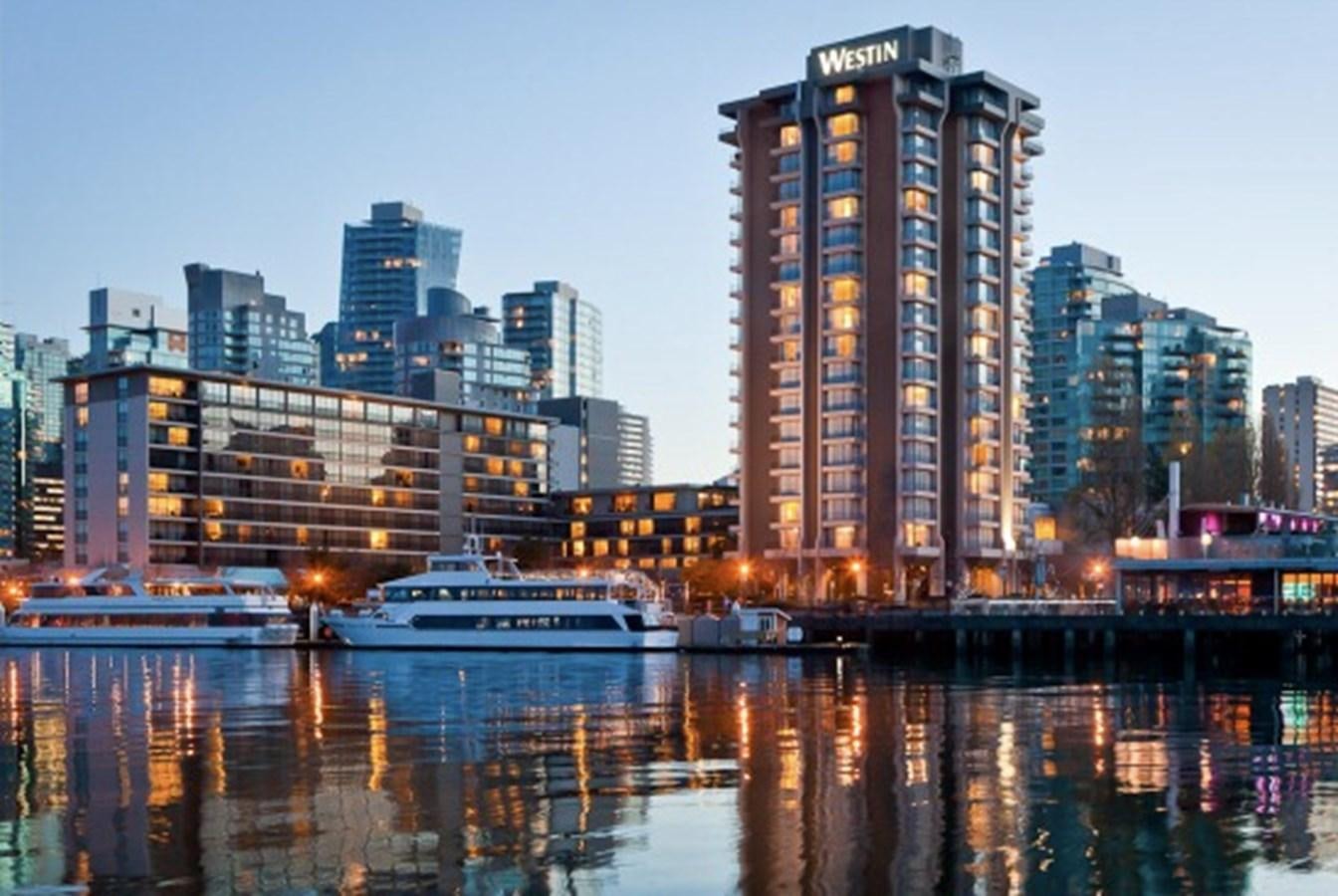 a city skyline at night aboard MAGIC CHARM Yacht for Sale