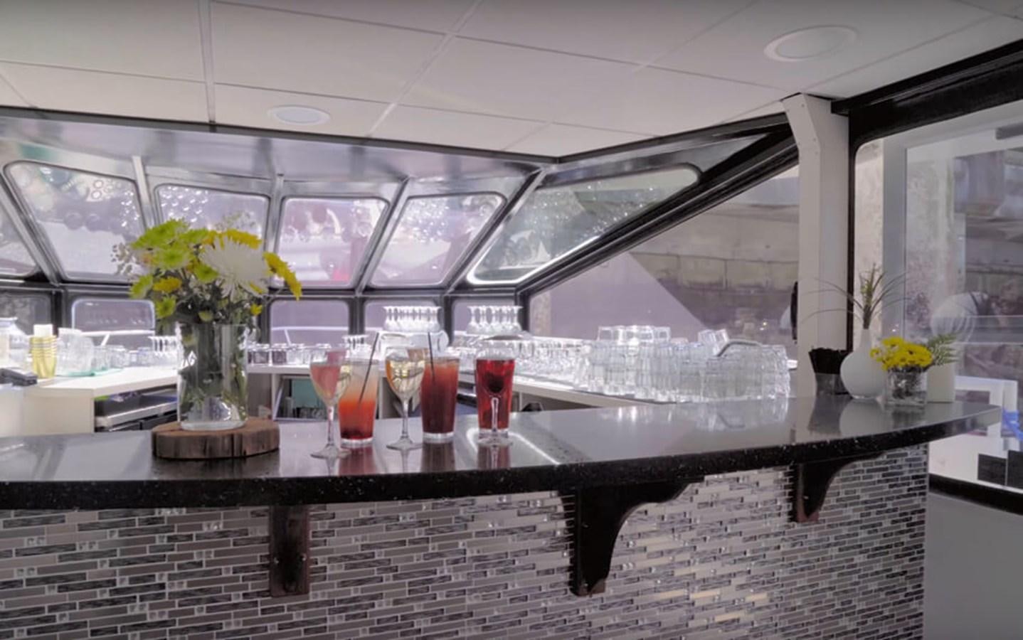 a group of glasses with drinks on a counter aboard MAGIC CHARM Yacht for Sale