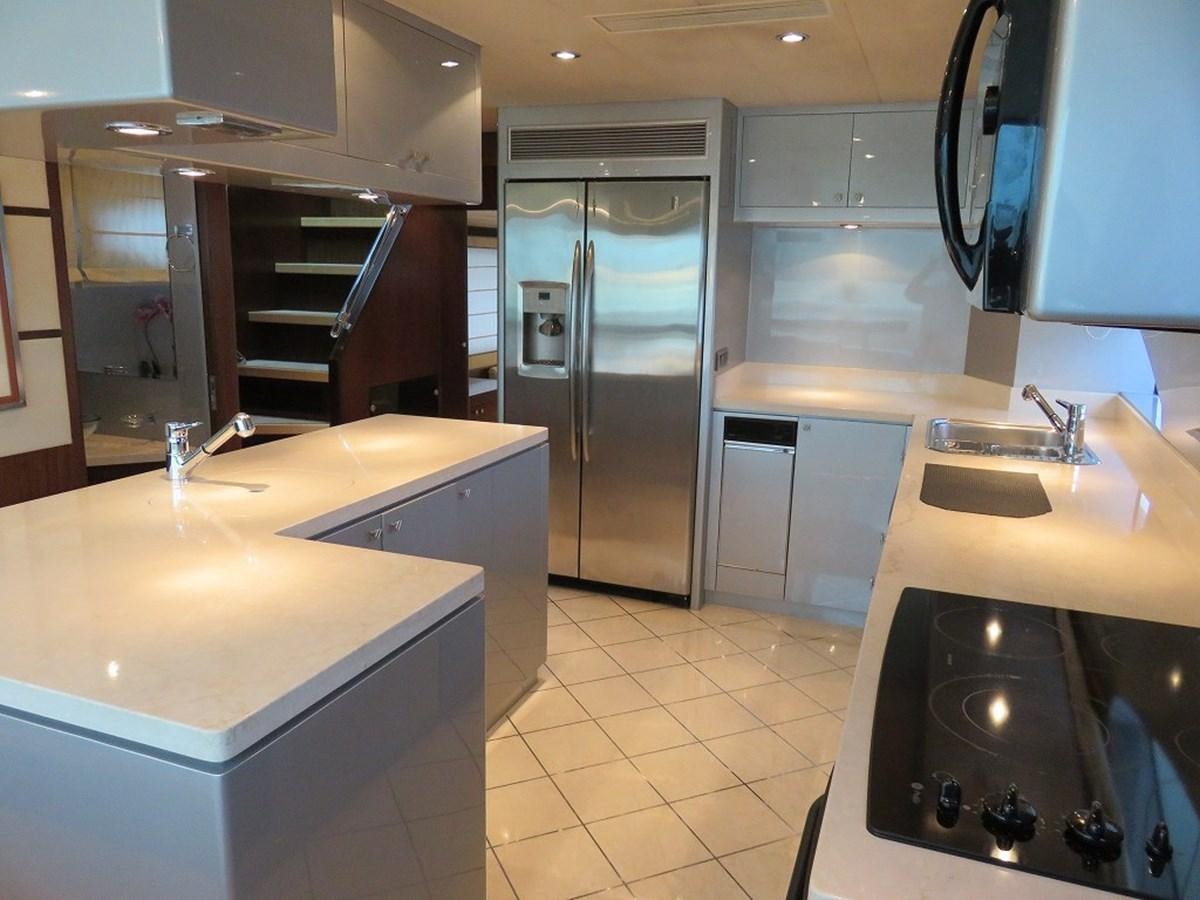a kitchen with a stainless steel refrigerator aboard ANA Yacht for Sale