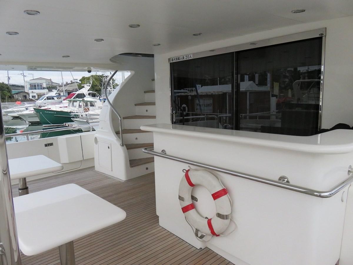 a room with a large window and a white shelf with objects on it aboard ANA Yacht for Sale