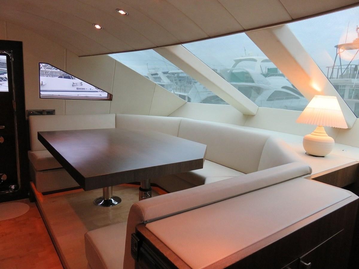 a room with a couch and a table with a lamp on it aboard ANA Yacht for Sale