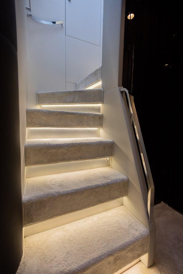 a white staircase in a room aboard ESCAPE Yacht for Sale