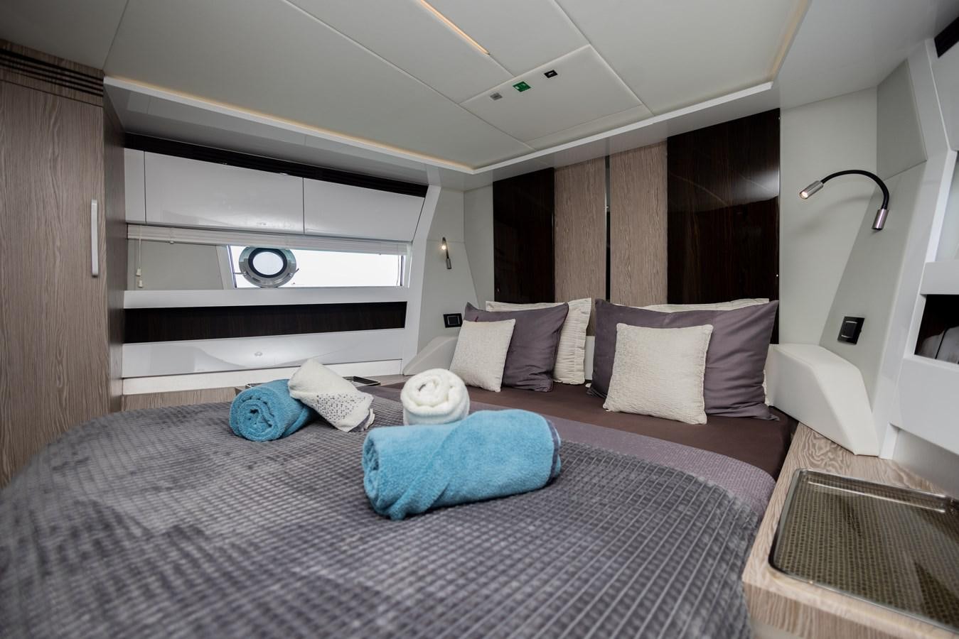 a bed with pillows and a mirror aboard ESCAPE Yacht for Sale