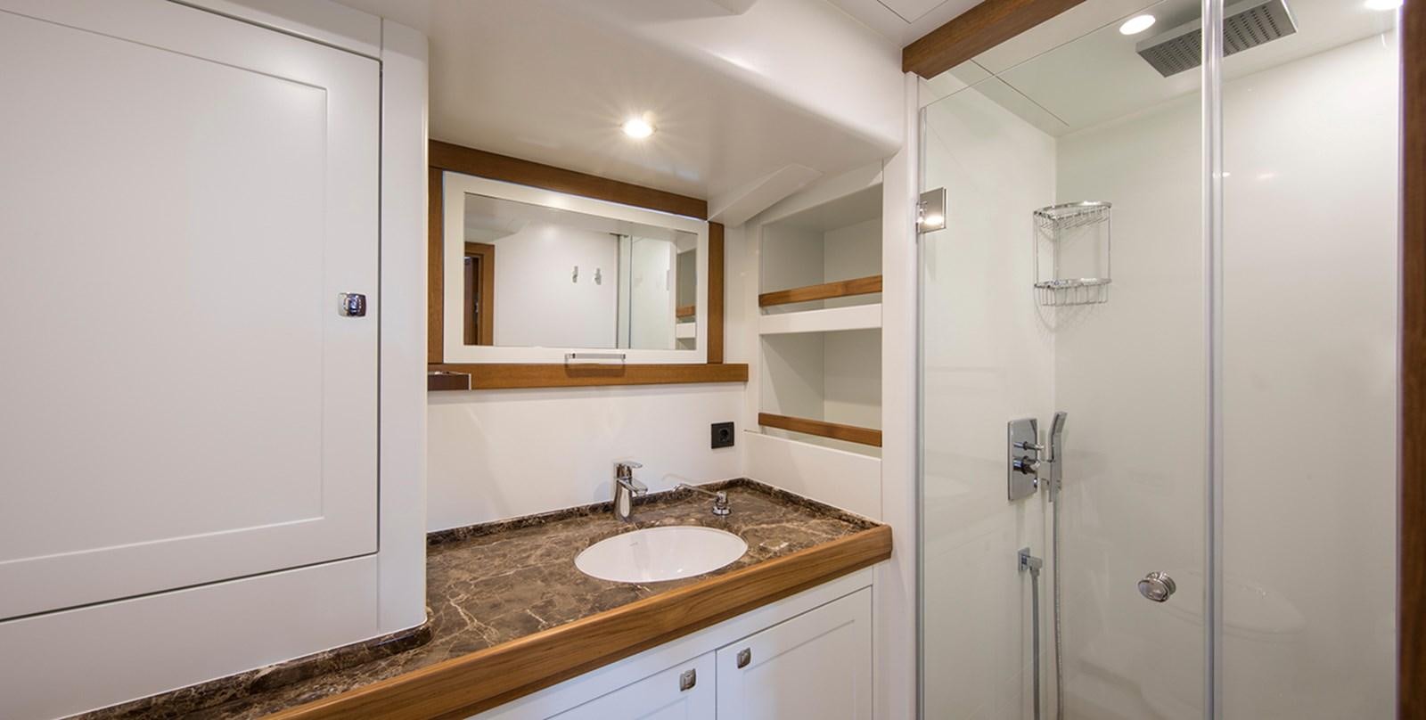 a bathroom with a sink and a shower unit aboard VAYU Yacht for Sale