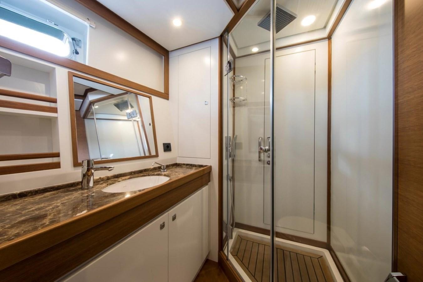 a bathroom with a glass shower aboard VAYU Yacht for Sale
