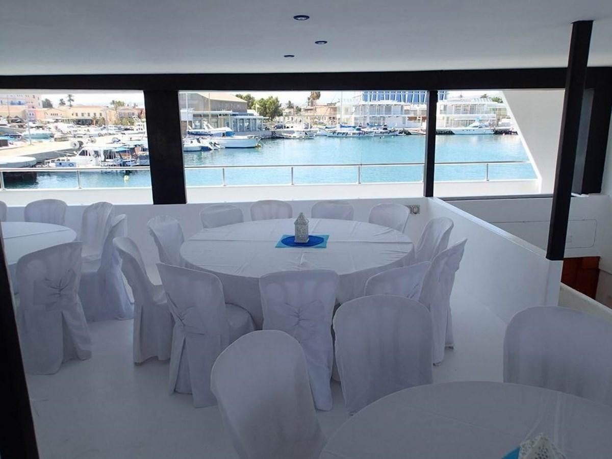 a room with tables and chairs aboard SALONE Yacht for Sale