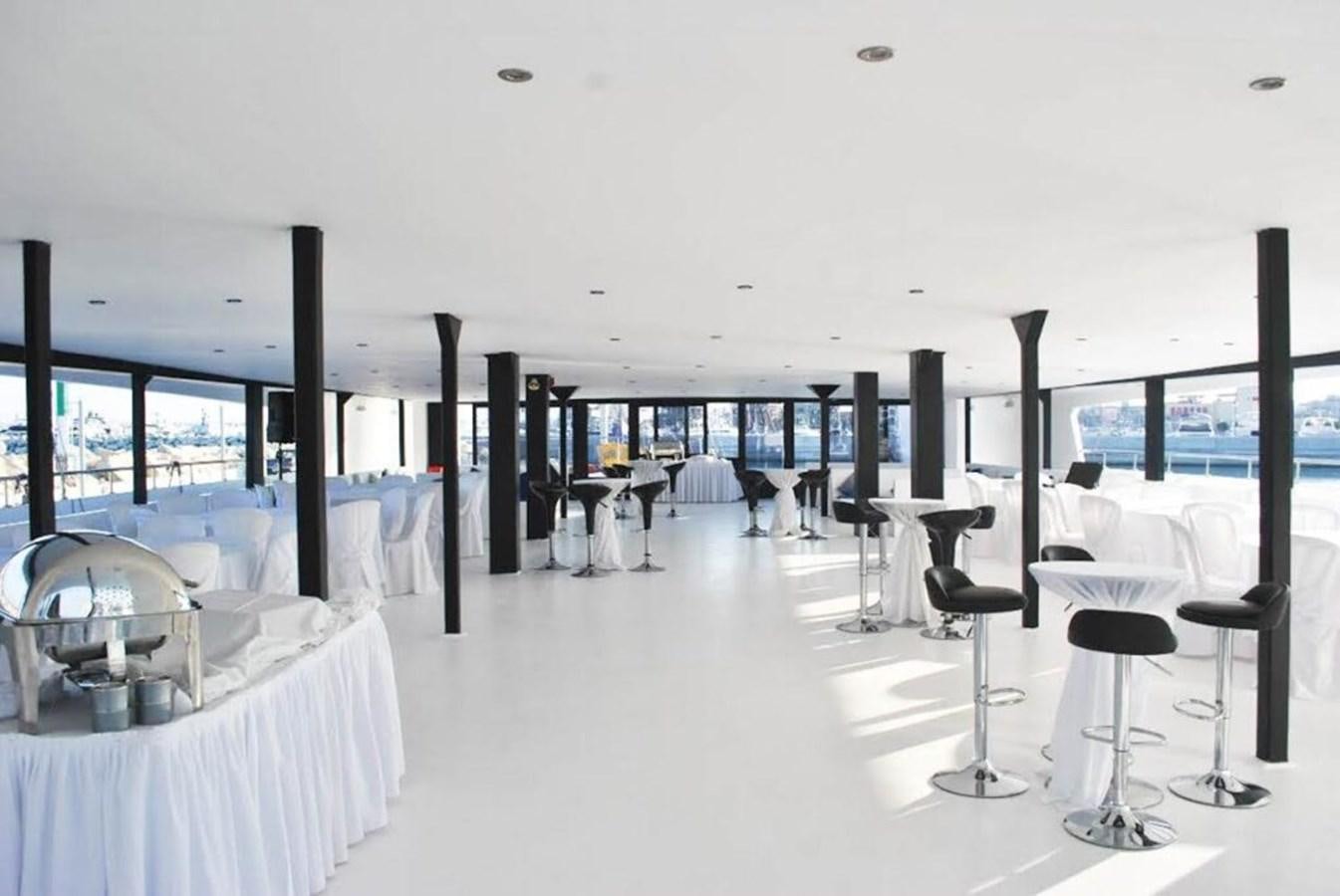 a room with tables and chairs aboard SALONE Yacht for Sale