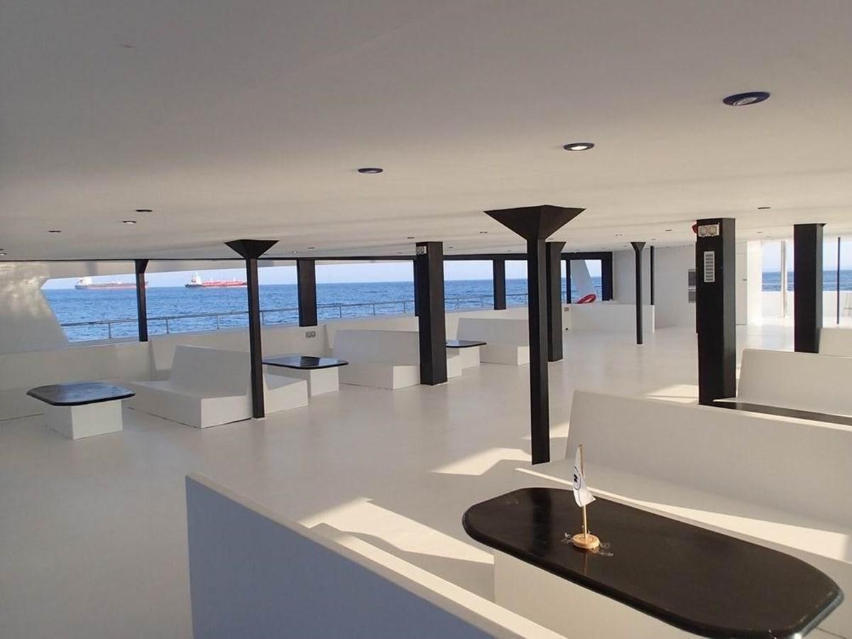 a room with a pool and a table with chairs aboard SALONE Yacht for Sale