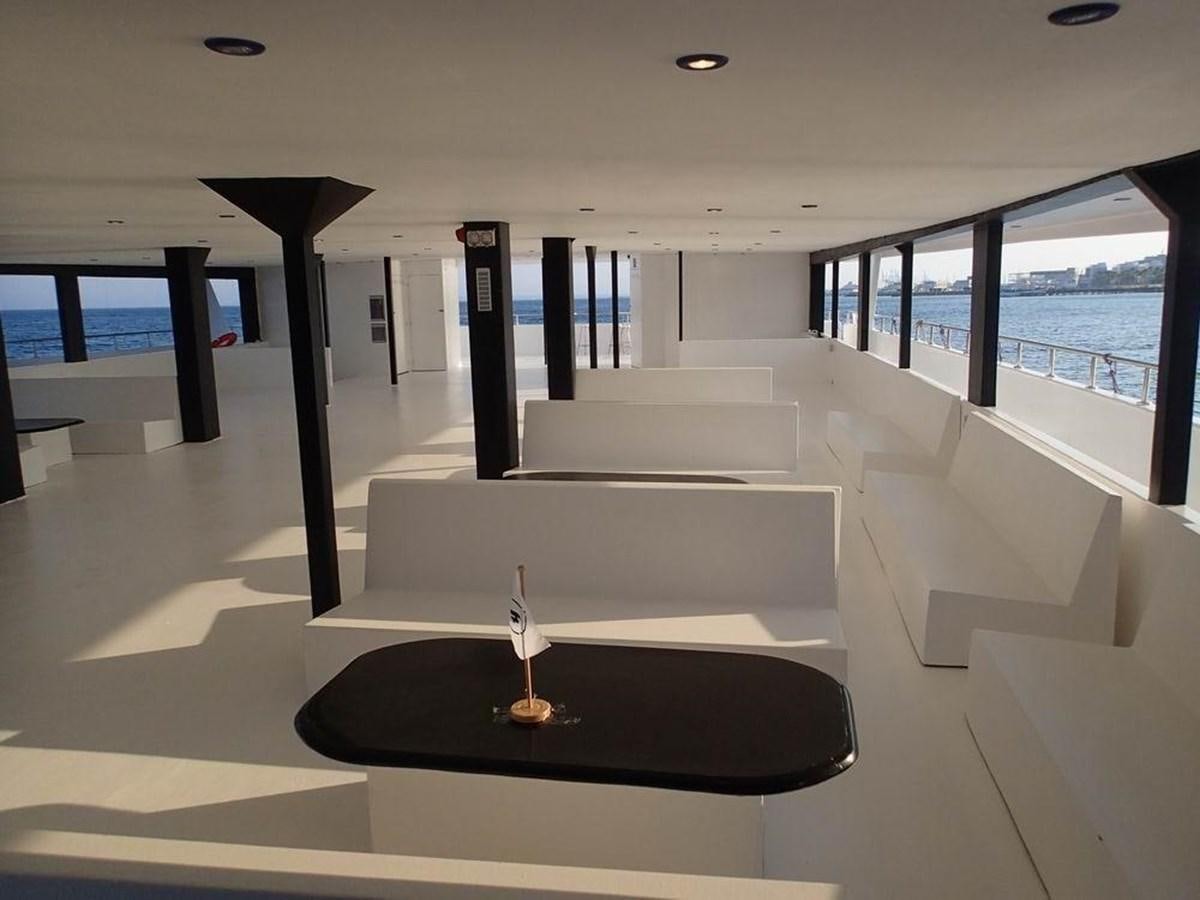 a room with a white couch and a black table and a black table aboard SALONE Yacht for Sale