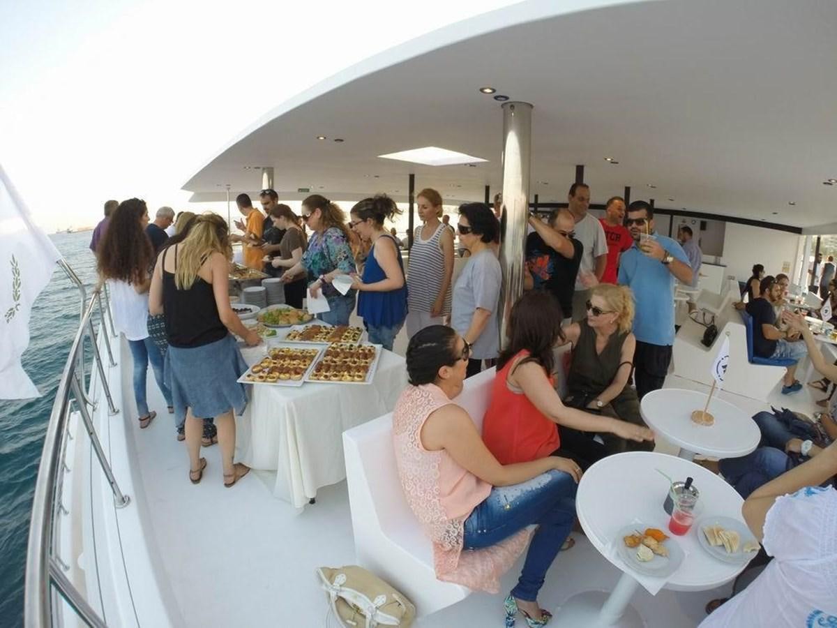 a group of people eating at a party aboard SALONE Yacht for Sale