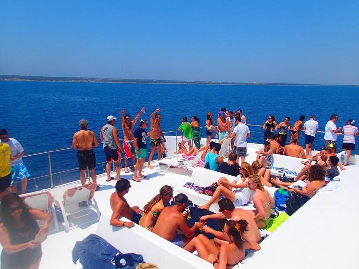a group of people on a beach aboard SALONE Yacht for Sale