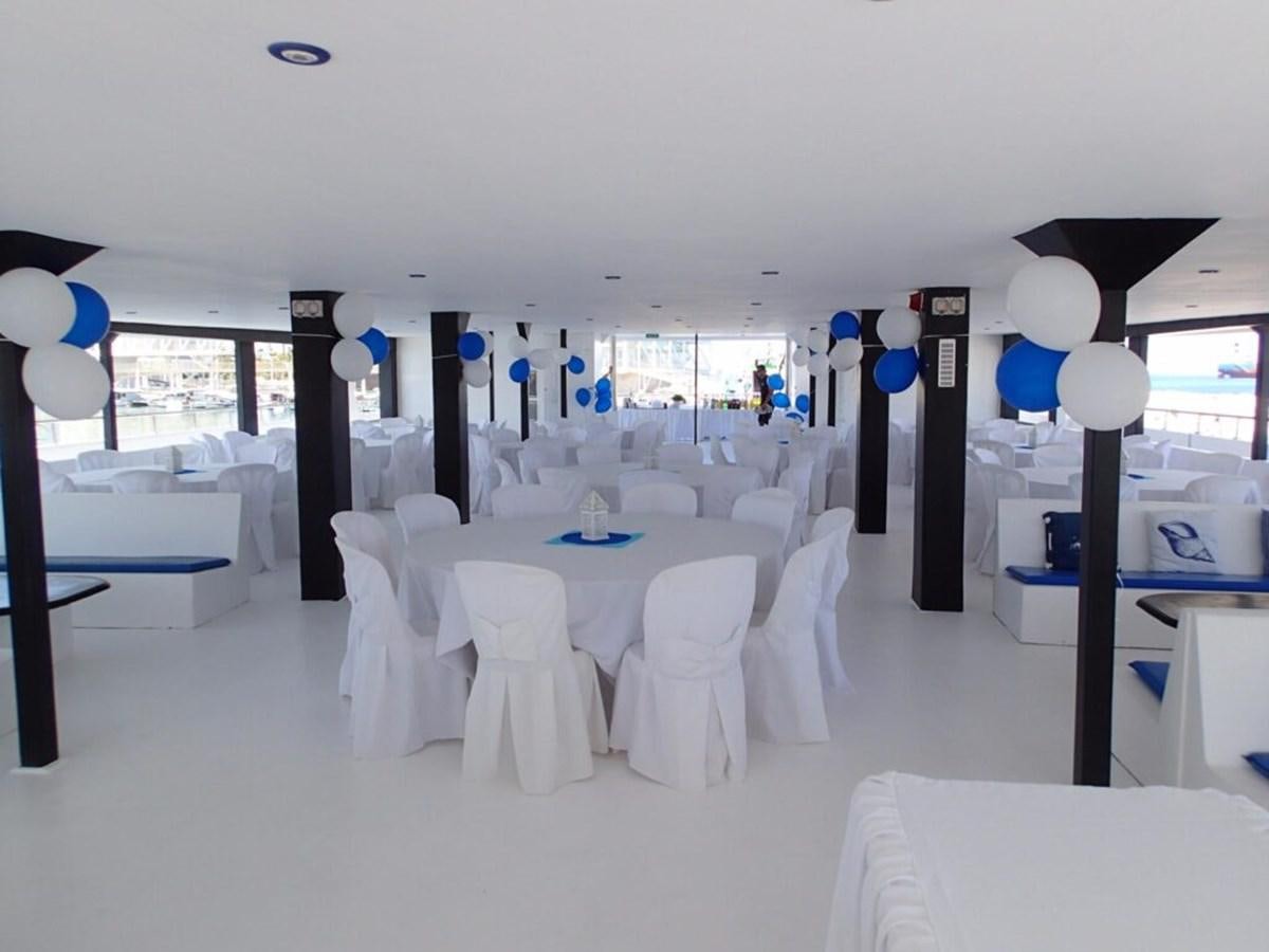 a room with tables and chairs aboard SALONE Yacht for Sale