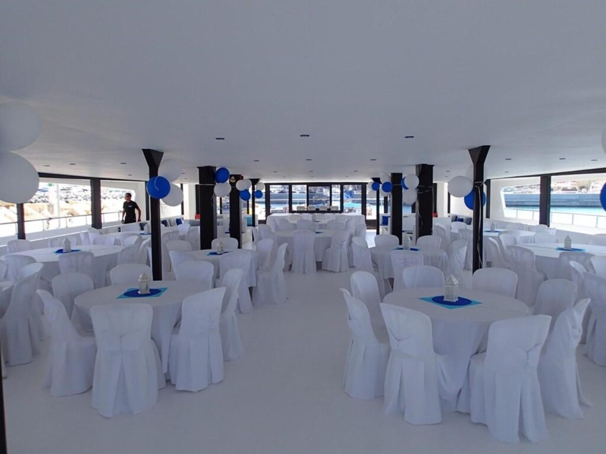 a room with tables and chairs aboard SALONE Yacht for Sale