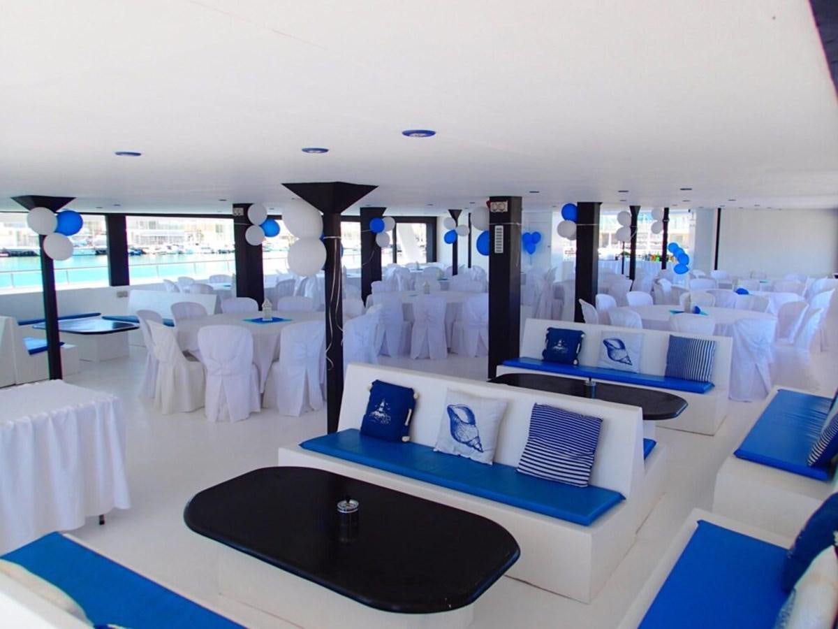 a room with tables and chairs aboard SALONE Yacht for Sale