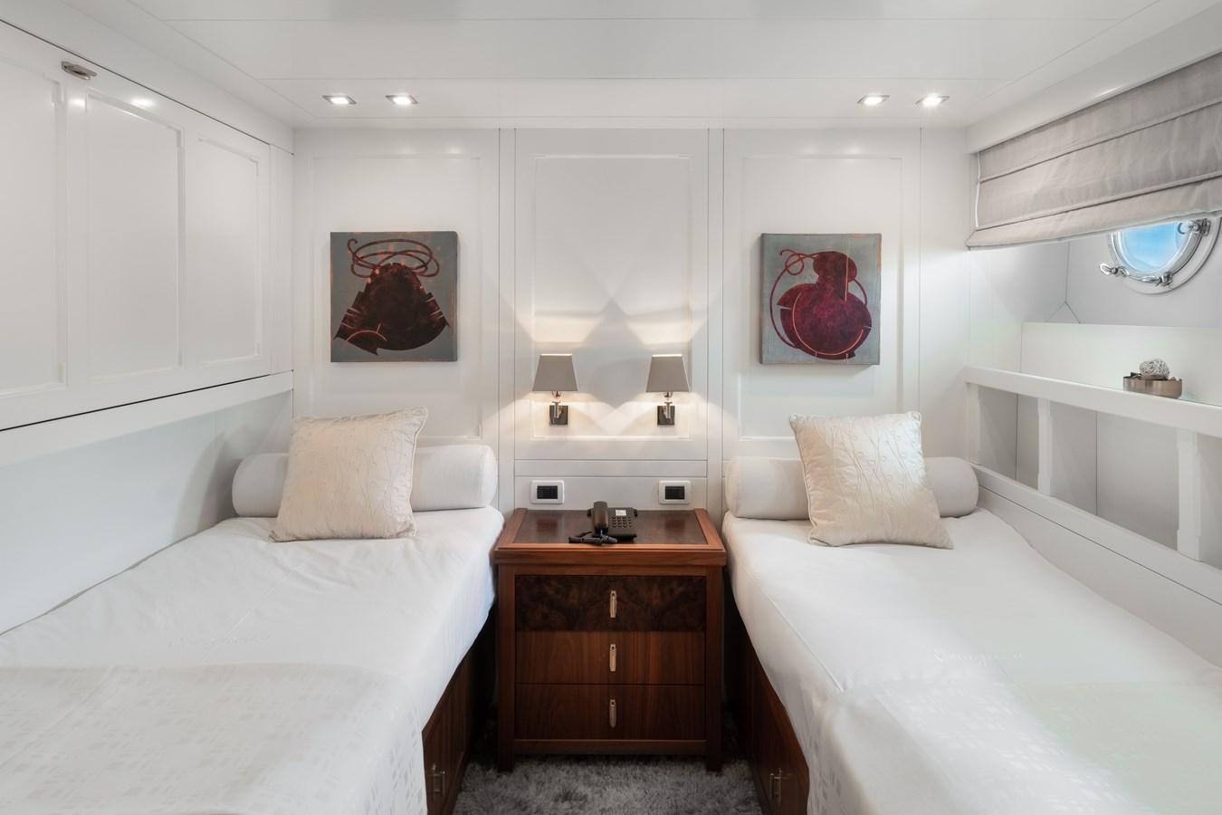 a room with white bedding and a mirror aboard EVERGREEN G Yacht for Sale