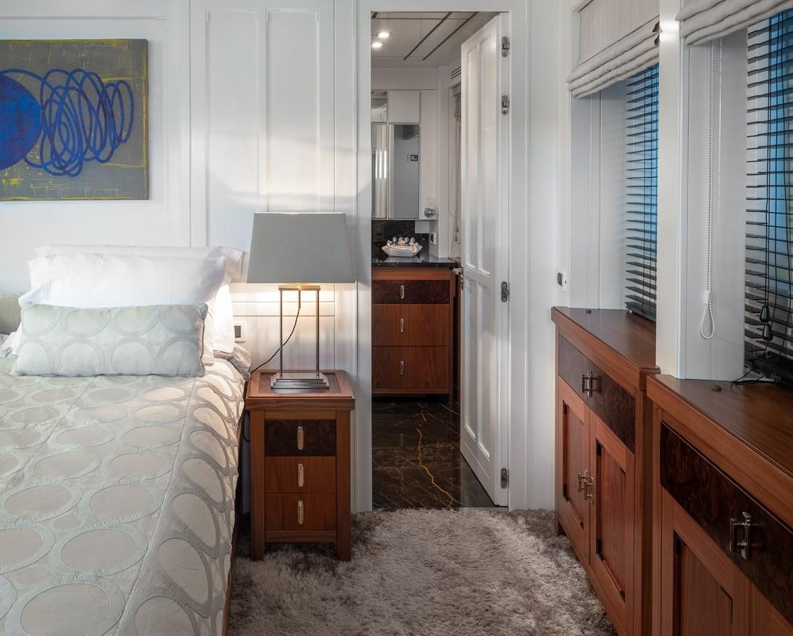 a bedroom with a bed and a desk aboard EVERGREEN G Yacht for Sale