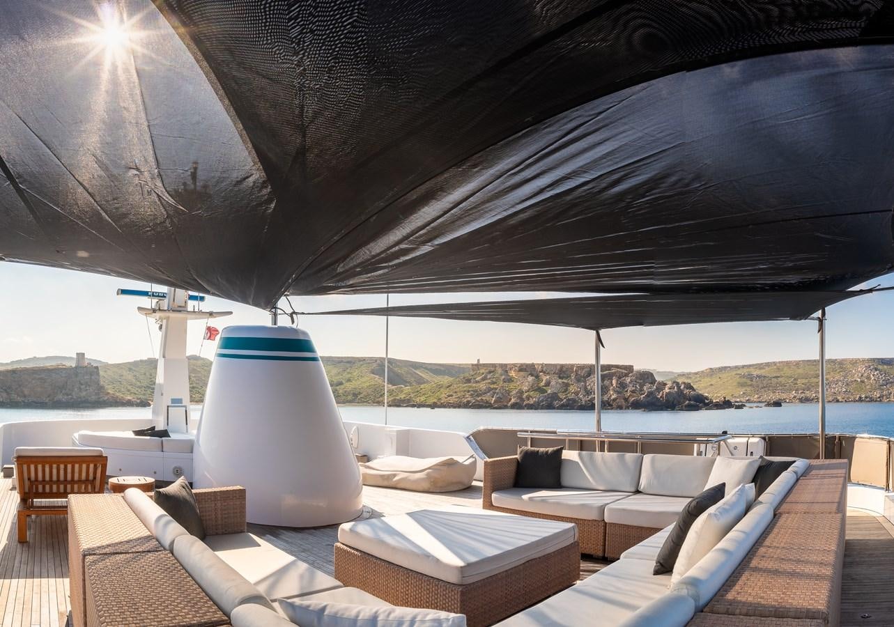 a large white lamp on a white table in a room with a large body of water and mountains aboard EVERGREEN G Yacht for Sale