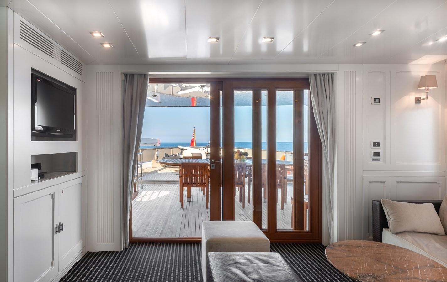 a living room with a balcony aboard EVERGREEN G Yacht for Sale