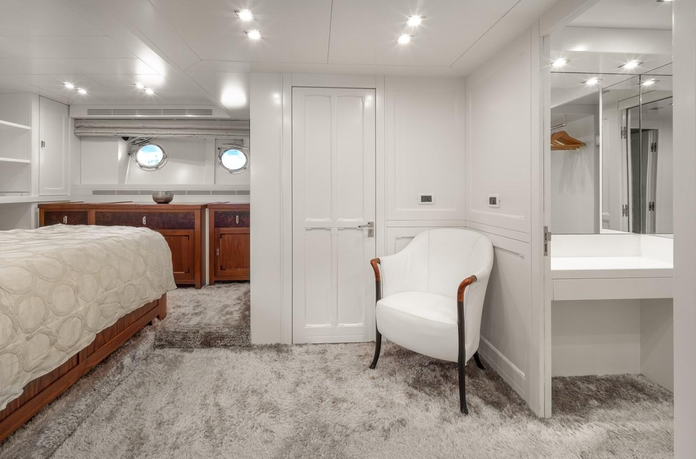 a bedroom with a bed and a chair aboard EVERGREEN G Yacht for Sale