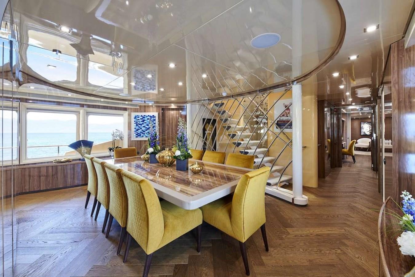 a room with a table and chairs aboard DALOLI Yacht for Sale