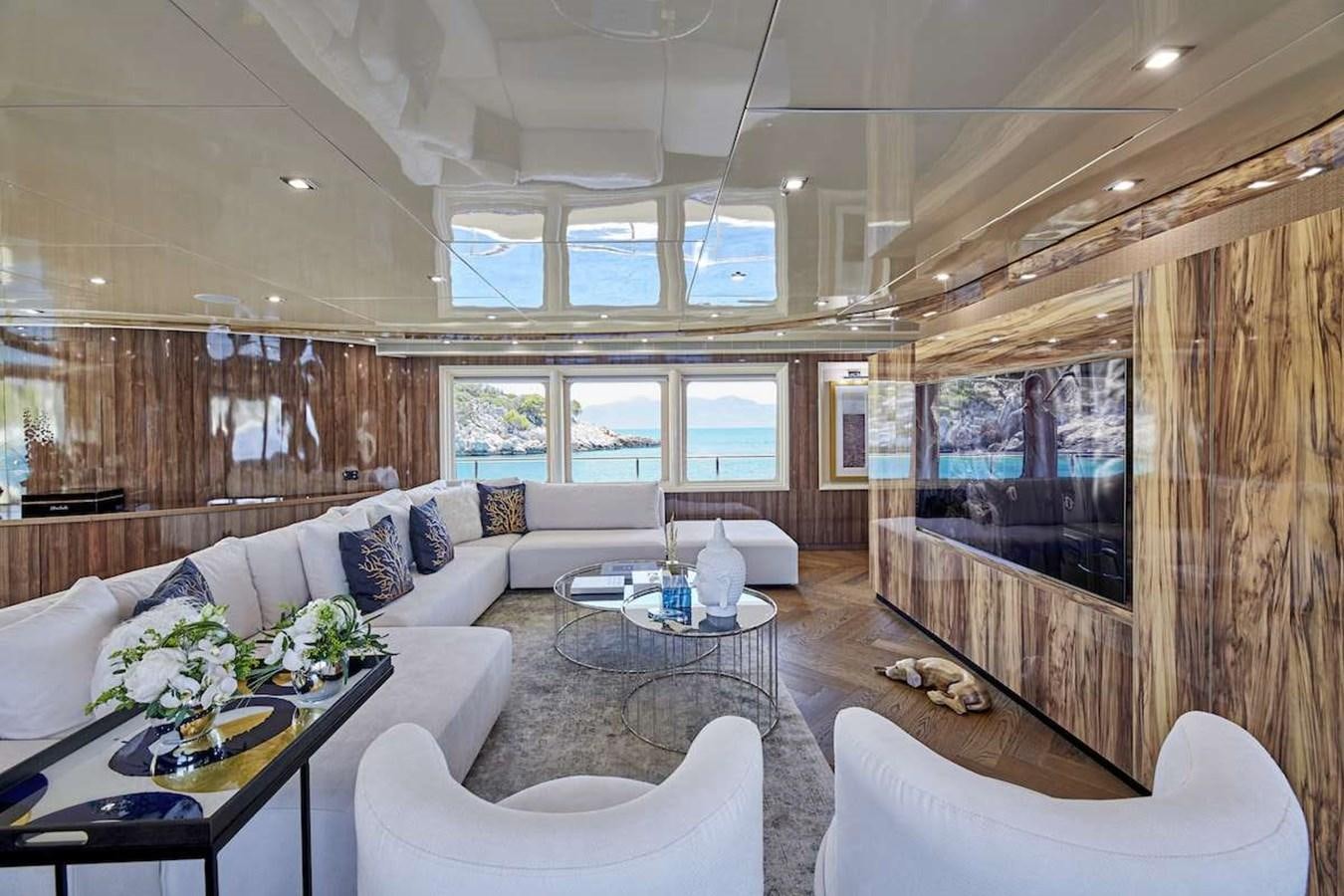 a living room with a large screen aboard DALOLI Yacht for Sale