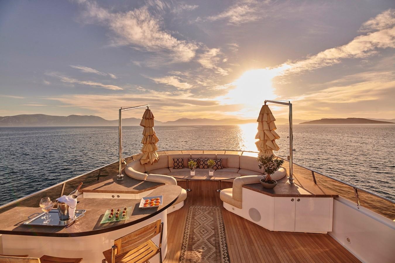 a deck with a view of the ocean and the ocean aboard DALOLI Yacht for Sale