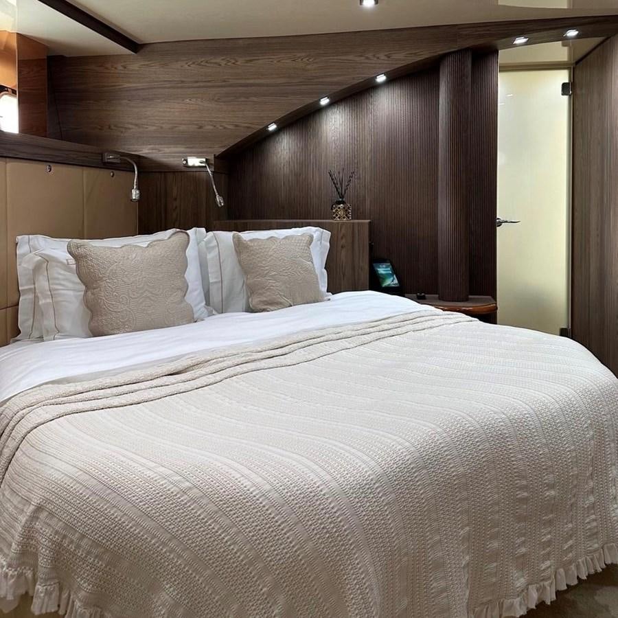 a bed with white sheets aboard DALOLI Yacht for Sale