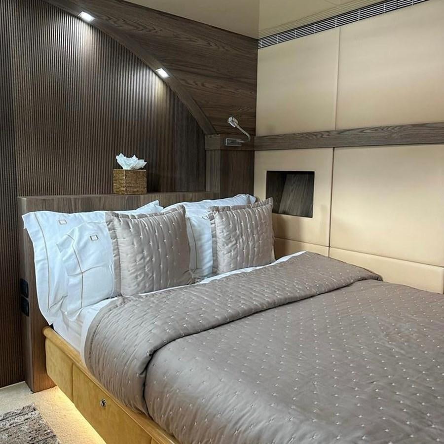 a bed with a white sheet aboard DALOLI Yacht for Sale