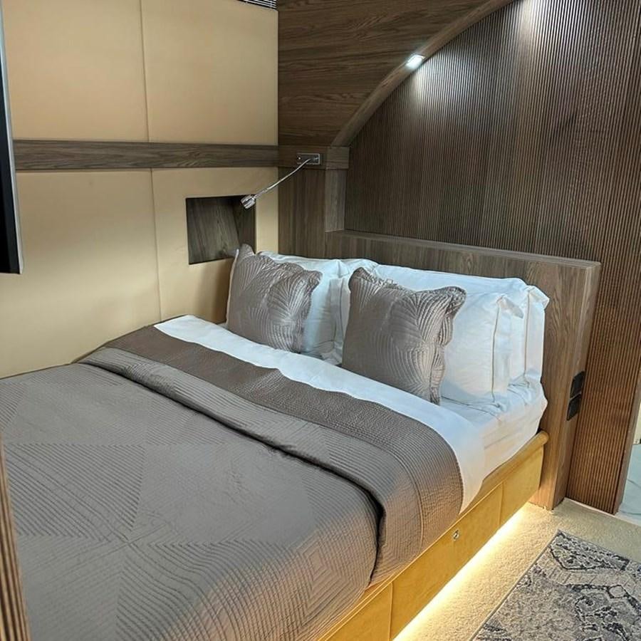 a bed with a light on the side aboard DALOLI Yacht for Sale
