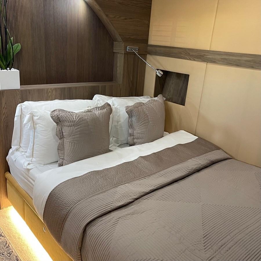 a bed with white sheets aboard DALOLI Yacht for Sale