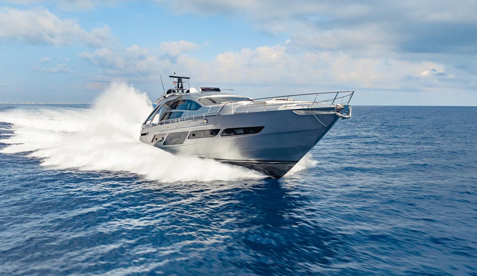 a white yacht in the water aboard STALLION Yacht for Sale