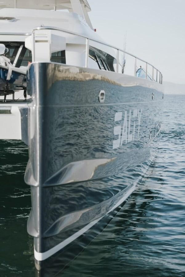 a boat with a large white sail aboard SALTY Yacht for Sale