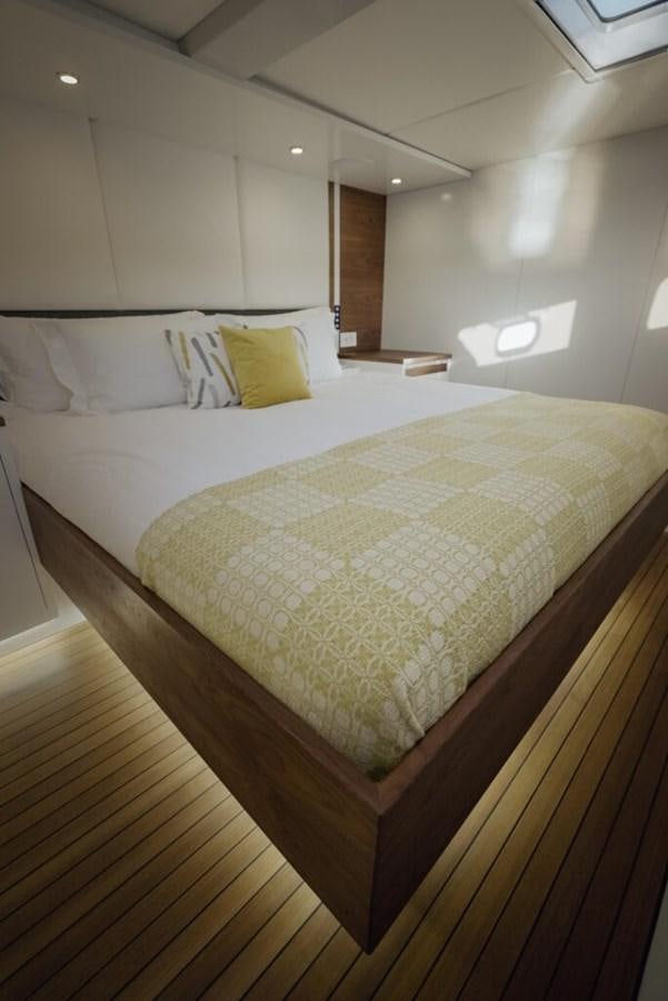 a bed with a white comforter aboard SALTY Yacht for Sale