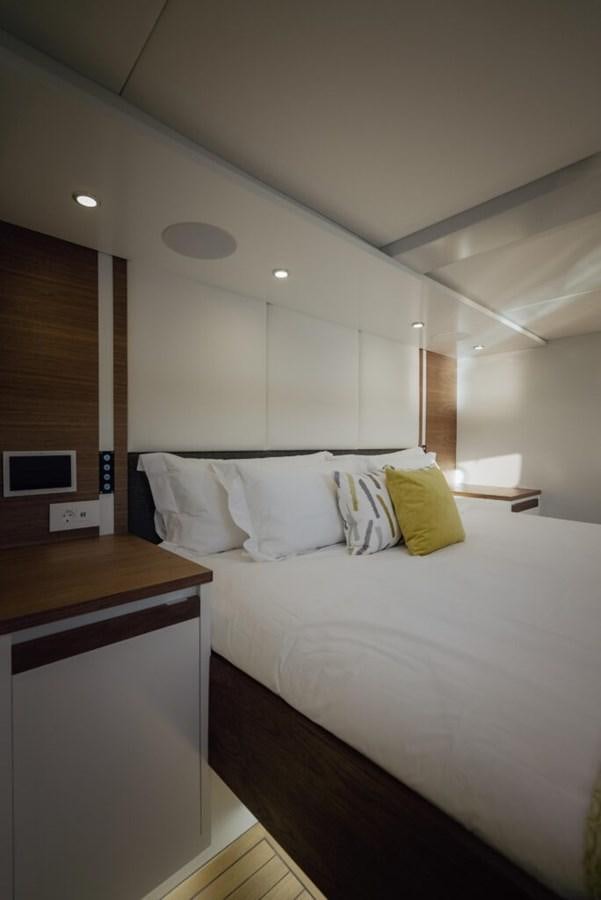 a bed with white sheets aboard SALTY Yacht for Sale