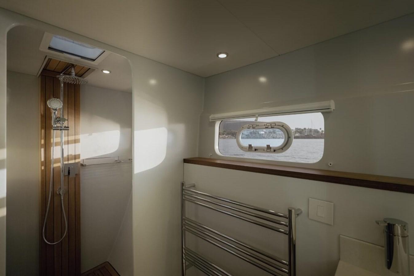 a room with a mirror and a shelf with wires aboard SALTY Yacht for Sale