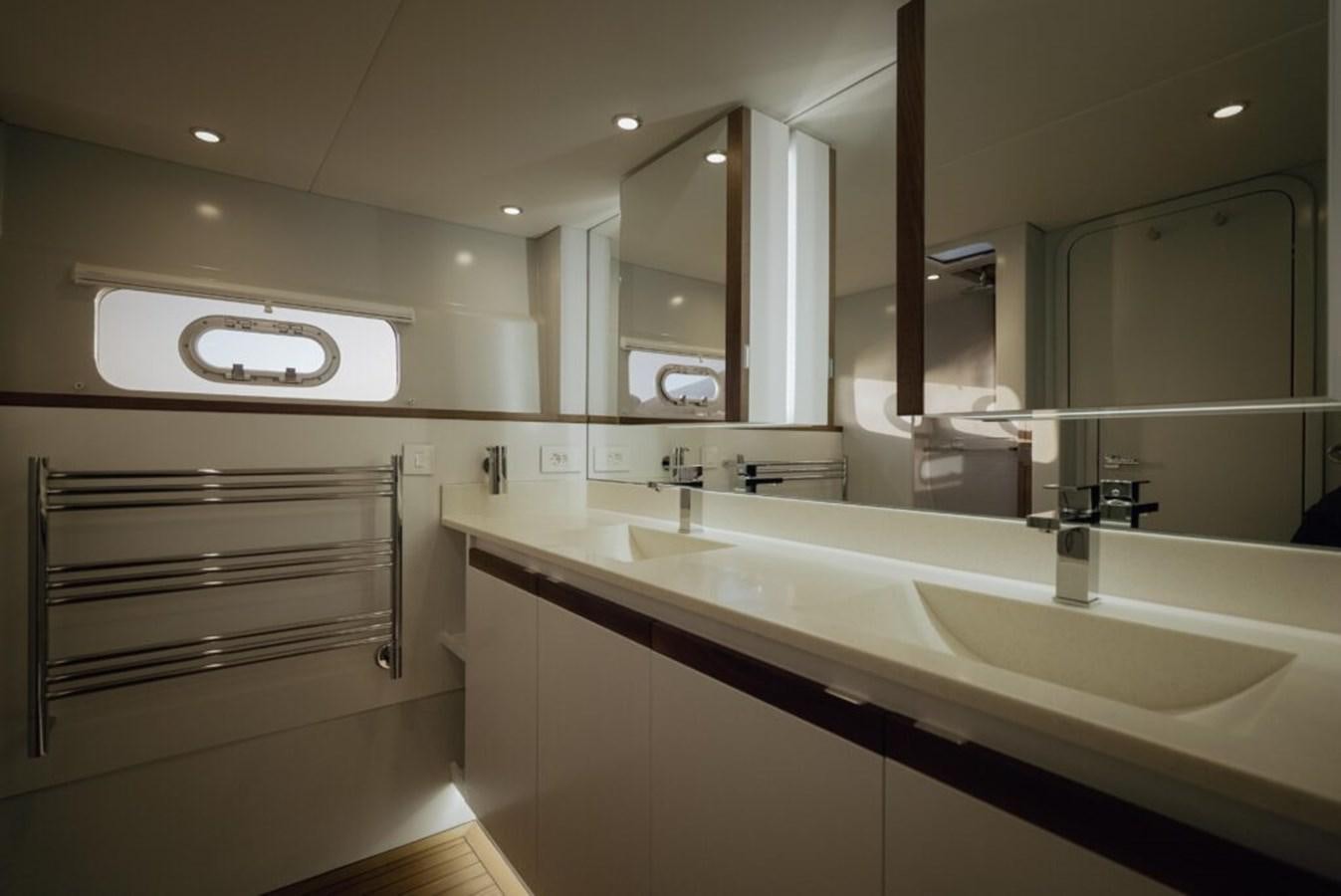 a bathroom with sinks and mirrors aboard SALTY Yacht for Sale