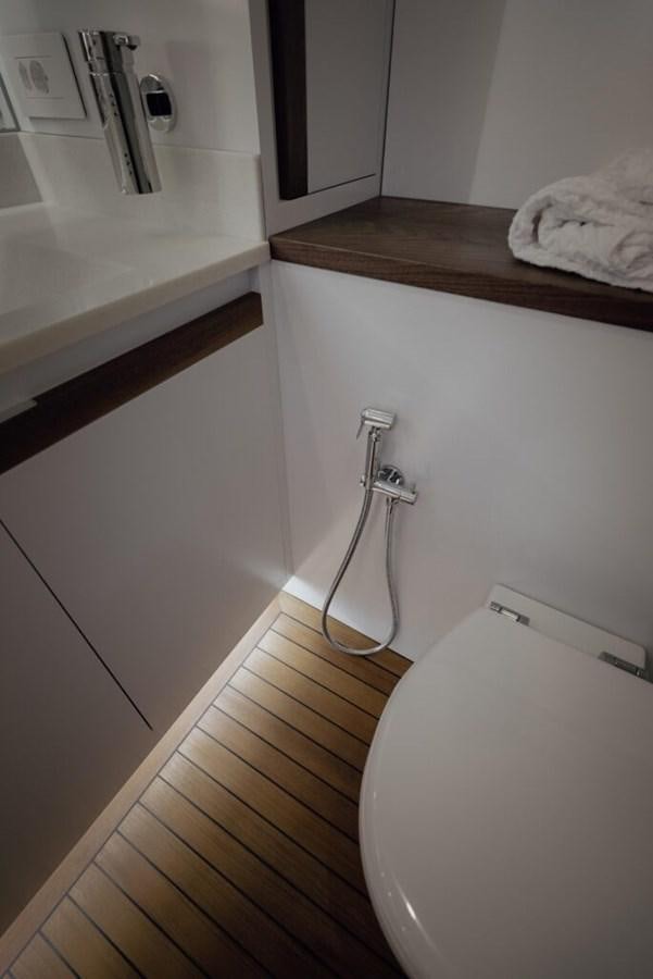 a bathroom with a sink and a mirror aboard SALTY Yacht for Sale