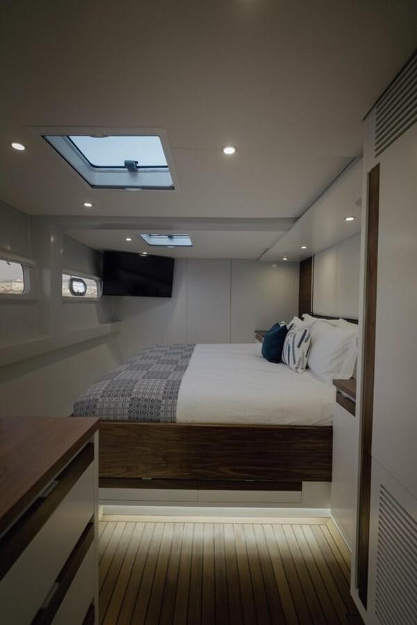 a bedroom with a bed and a desk aboard SALTY Yacht for Sale