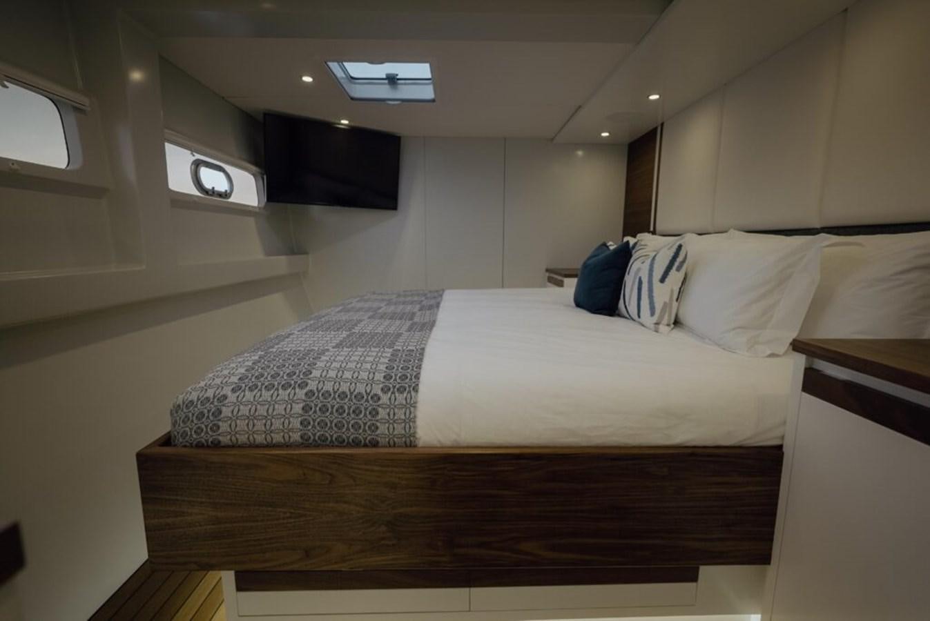 a bed with white sheets aboard SALTY Yacht for Sale