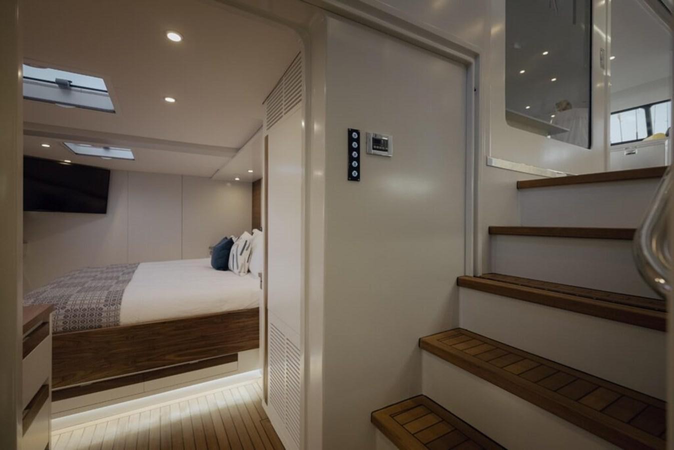 a room with a bed and a mirror aboard SALTY Yacht for Sale
