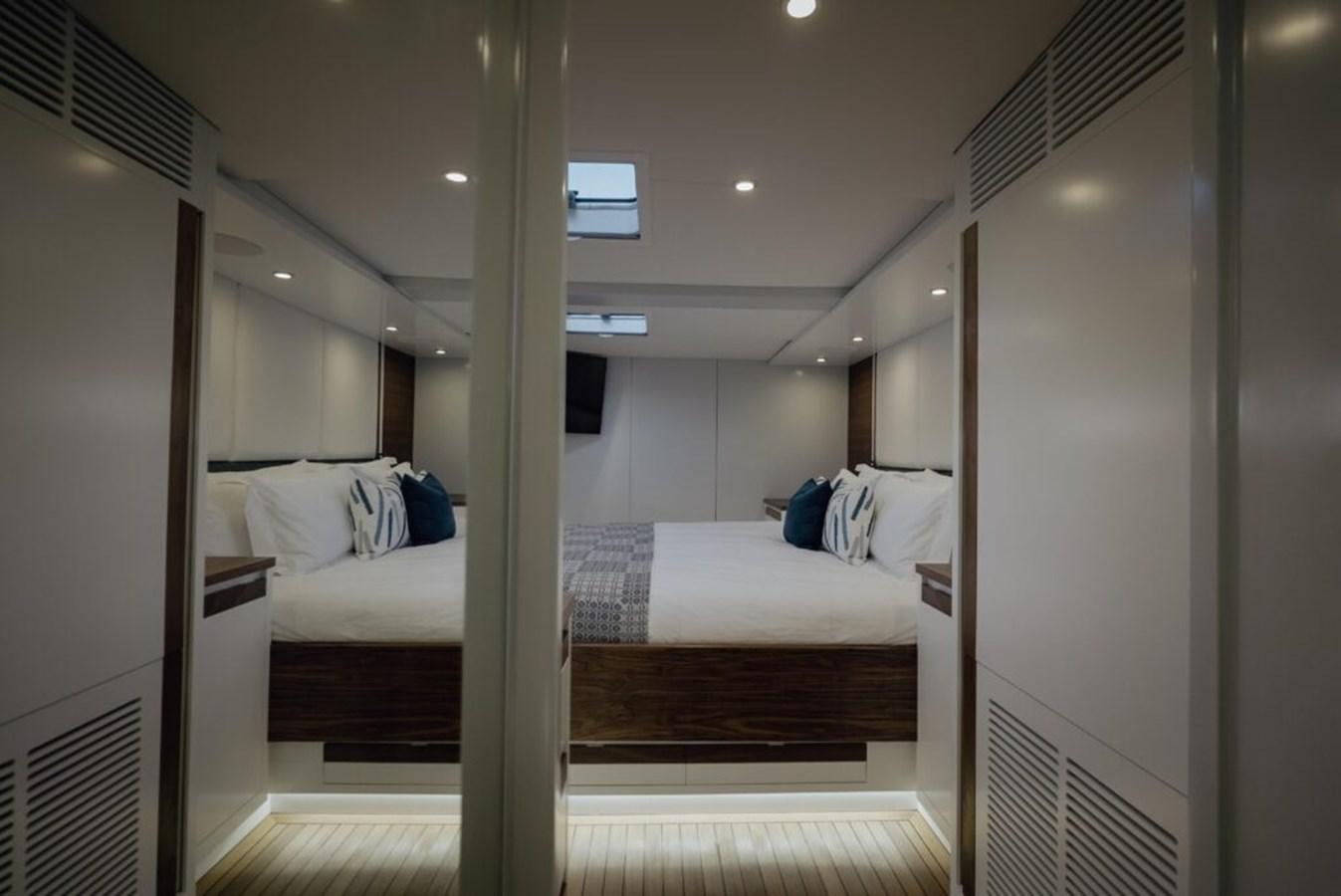 a room with a bed and a window aboard SALTY Yacht for Sale